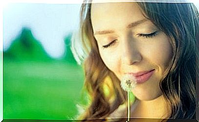 woman holding dandelion