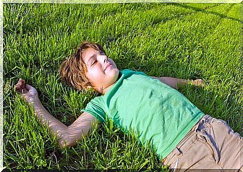 boy lying on the grass