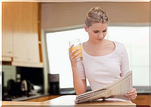 woman reading newspaper in the morning