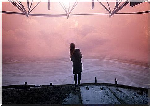 Woman looking at the horizon at dusk.