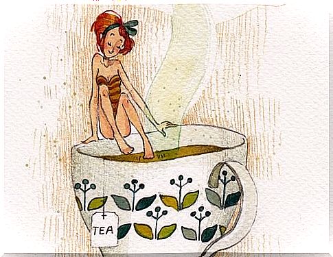 woman getting into cup of tea