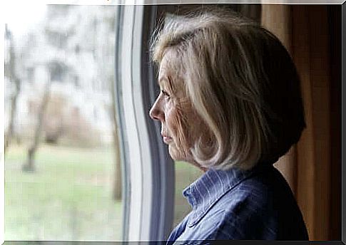 elderly woman looking out the window