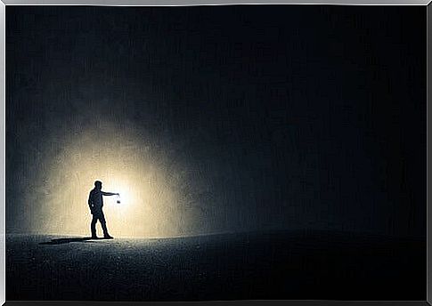 man with lamp in the dark