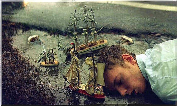 boy sleeping in puddle of water